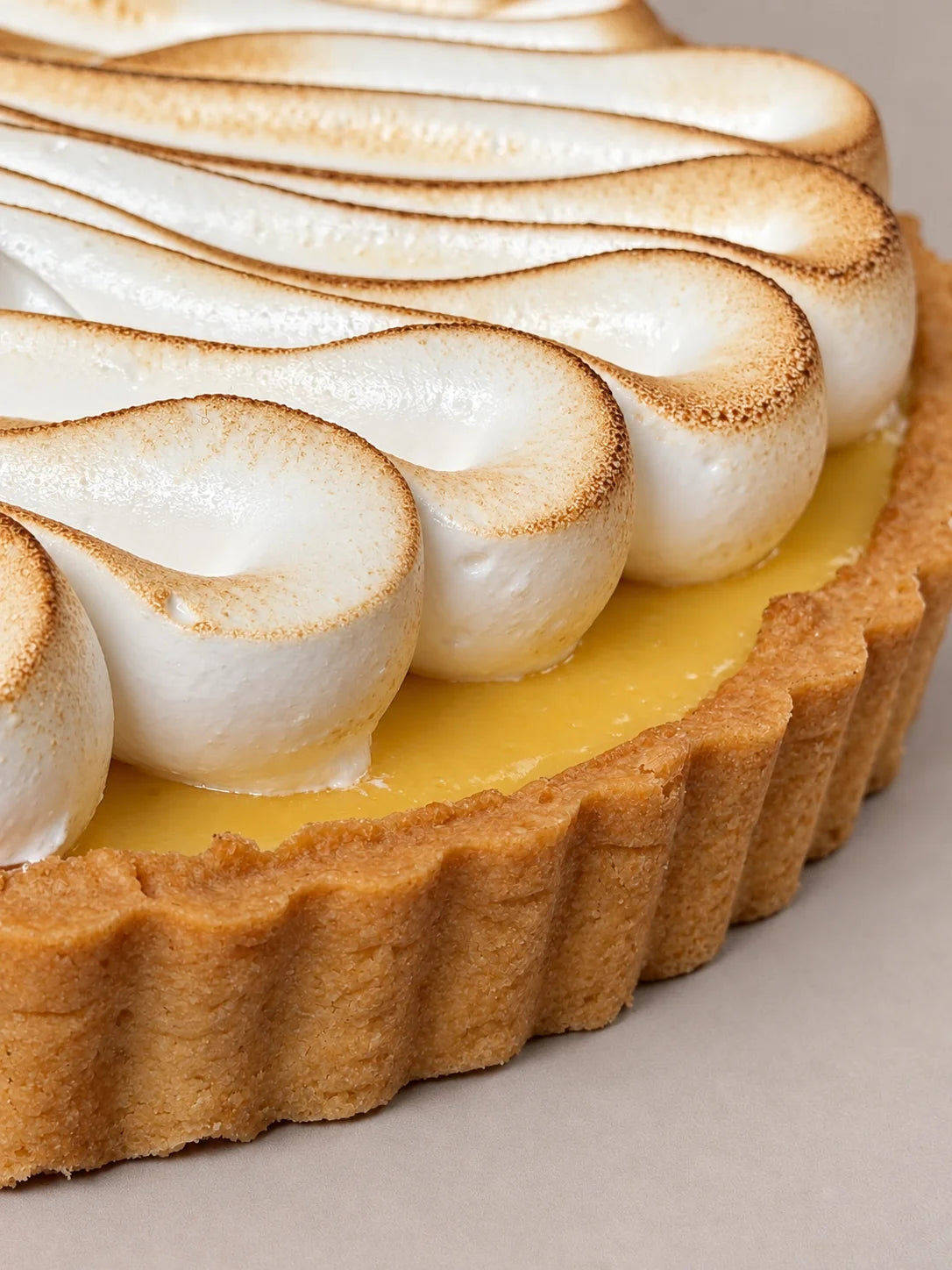 Detalle interior de tarta de maracuyá sin gluten de NICOLINA Madrid, con crema tropical y merengue suave tostado.
